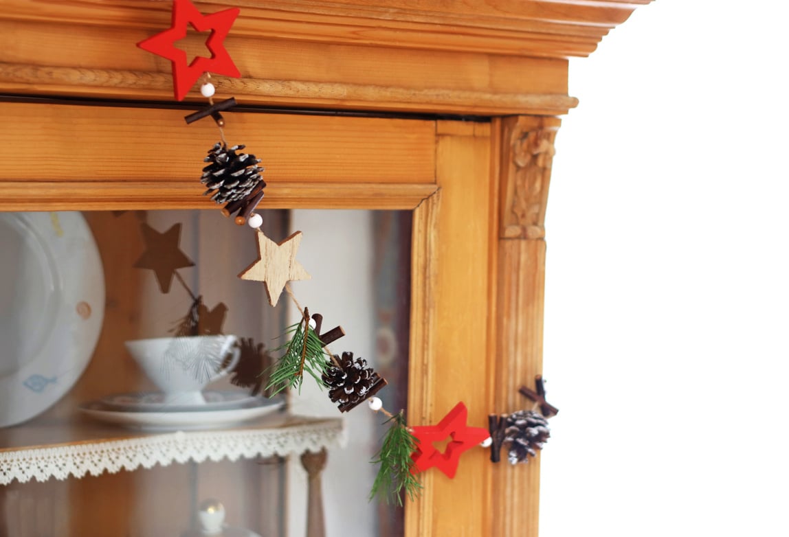 chain with christmas ornaments hanging on a retro cabinet